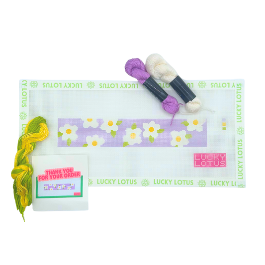 Daisy needlepoint canvas with white flowers on a lavender background and coordinating threads