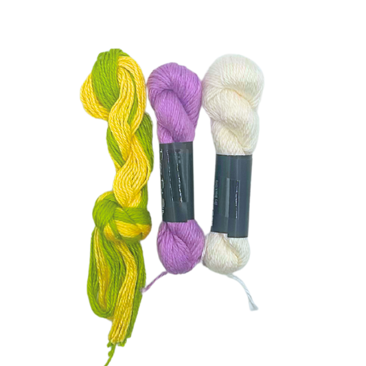 Coordinating needlepoint threads in green, yellow, lavender and cream for the Daisies canvas
