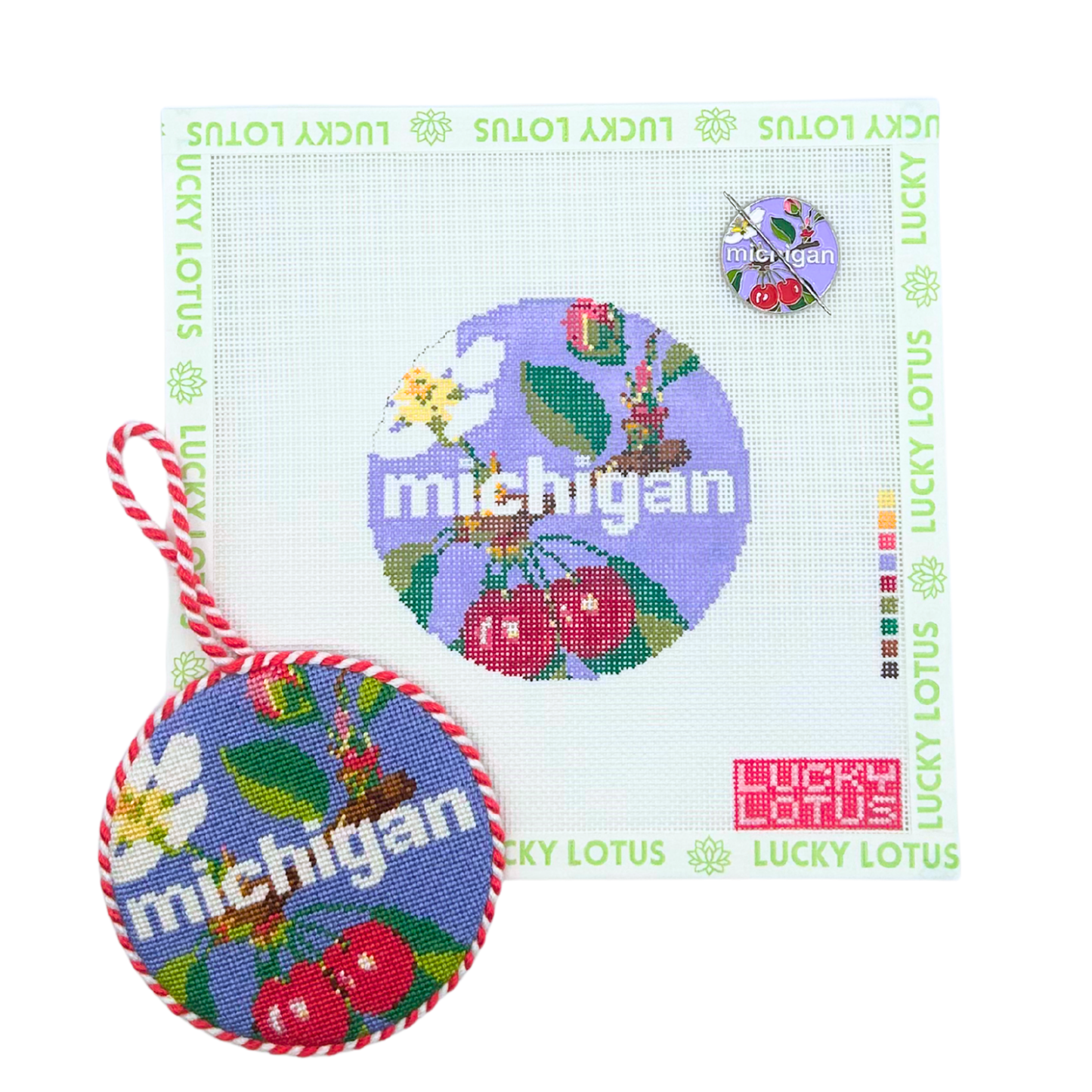 Michigan state needlepoint canvas with matching needle minder and finished round ornament featuring cherries, apple blossom, robin, and other Michigan inspired details.