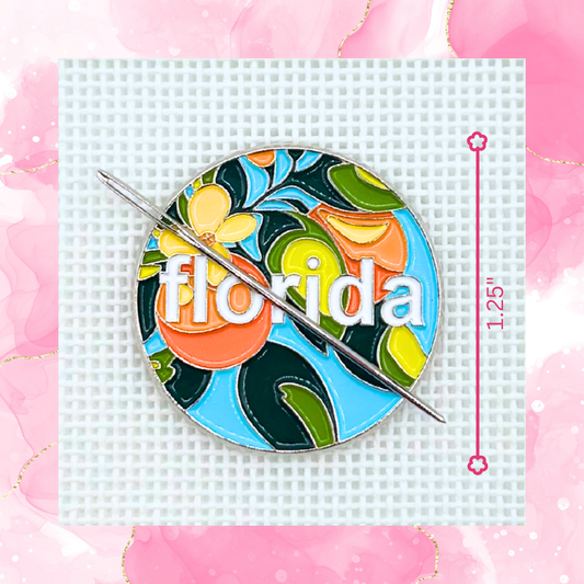 Florida needle minder featuring colorful oranges, citrus blossoms, tropical leaves, and Florida lettering displayed on needlepoint canvas