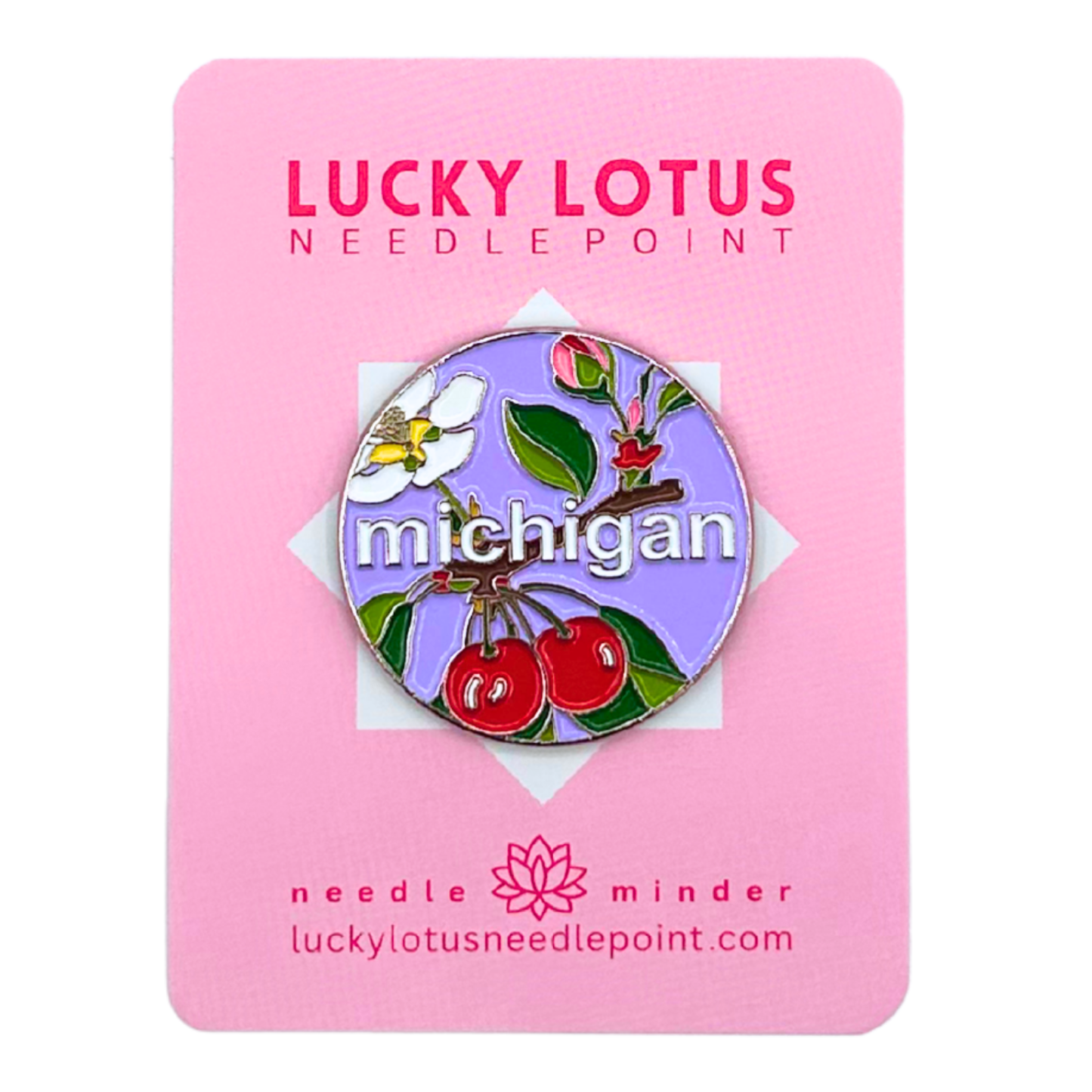 Michigan needle minder with red cherries, an apple blossom, green leaves, and Michigan lettering on a lavender background.