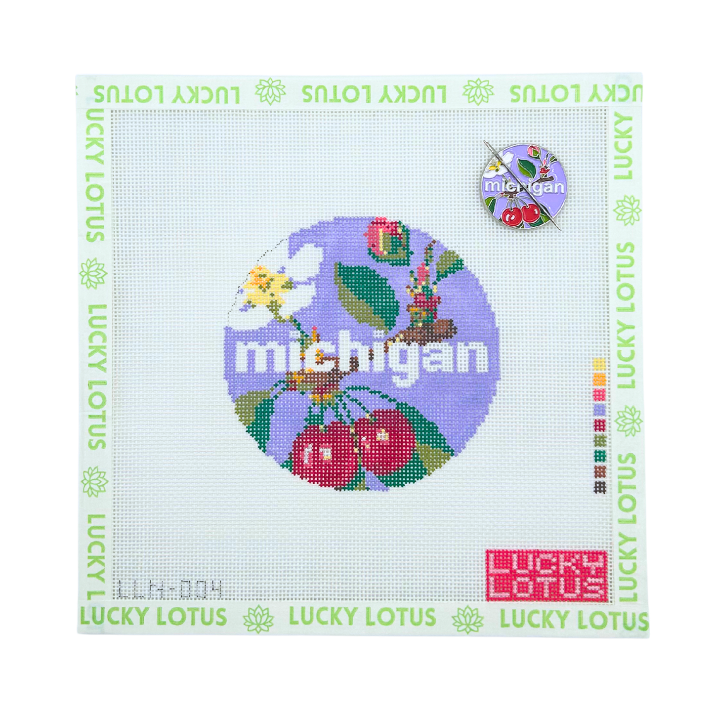 Michigan state needlepoint canvas featuring cherries, apple blossom, robin, and colorful Michigan inspired motifs with the matching Michigan needle minder.