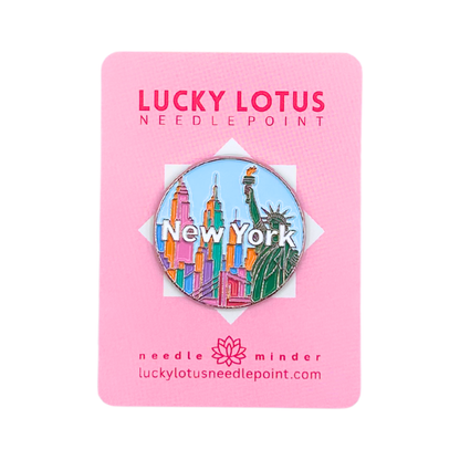 New York needle minder featuring the Statue of Liberty, colorful NYC skyline, and New York lettering on Lucky Lotus Needlepoint packaging