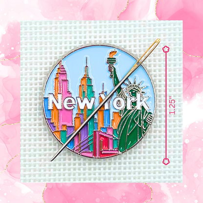 New York needle minder on needlepoint canvas featuring the Statue of Liberty, colorful skyline, and New York lettering