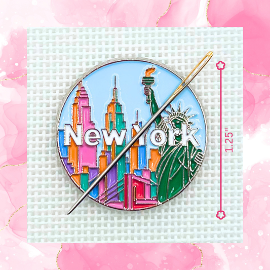 New York needle minder on needlepoint canvas featuring the Statue of Liberty, colorful skyline, and New York lettering