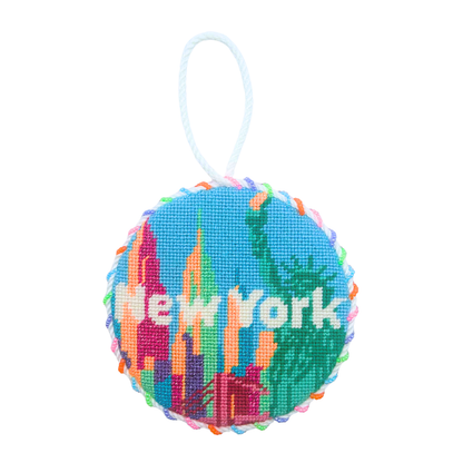 Finished New York City needlepoint ornament featuring a colorful skyline, Statue of Liberty, and “New York” lettering