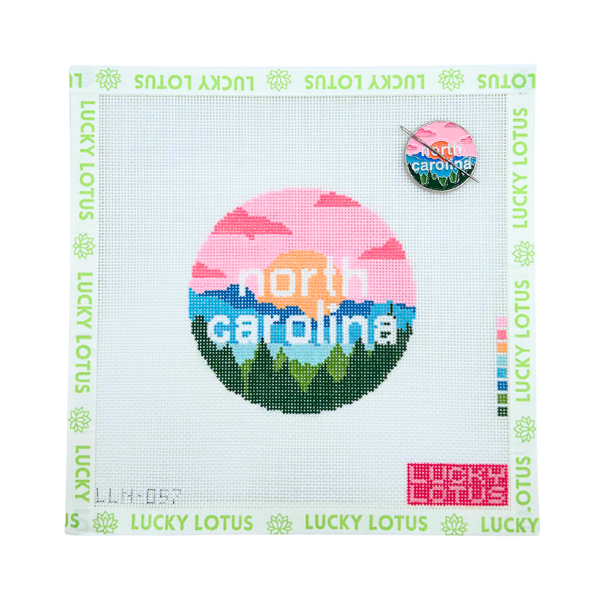 North Carolina state needlepoint canvas featuring mountains, pine trees and a colorful sunset with the matching North Carolina needle minder.