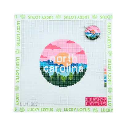 North Carolina state needlepoint canvas featuring mountains, pine trees and a colorful sunset with the matching North Carolina needle minder.