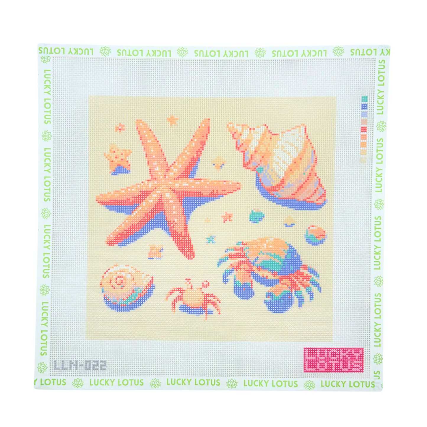 Coastal needlepoint canvas featuring a starfish, seashells and hermit crabs on a sandy background