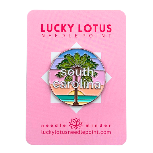 South Carolina needle minder featuring a palmetto tree against a colorful coastal sunset with South Carolina lettering.