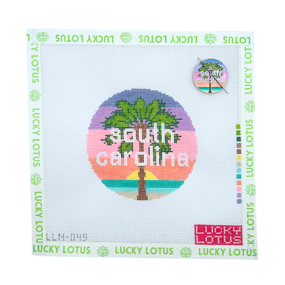 South Carolina state needlepoint canvas featuring a palm tree and colorful coastal sunset with the matching South Carolina needle minder.