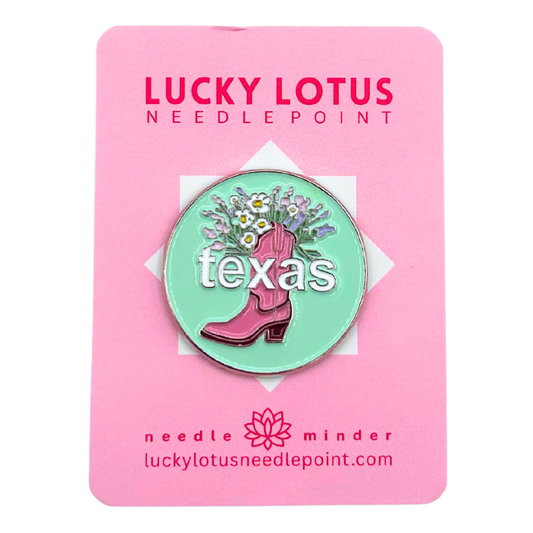 Texas needle minder featuring a pink cowboy boot filled with colorful wildflowers on a mint green background with Texas lettering.